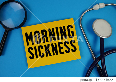 Morning Sickness text with Stethoscope and magnifying glass on blue background Morning Sickness text with Stethoscope and magnifying glass on blue background 132271622