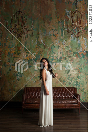 Stylish young female model brunette looking at camera indoor, full length portrait 132271812