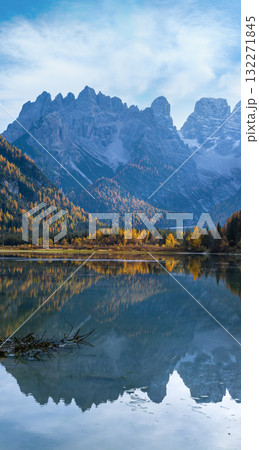 Autumn peaceful alpine lake Durrensee or Lago di Landro.  Snow-capped Cristallo rocky mountain group behind, Dolomites, Italy, Europe. Picturesque traveling, seasonal and nature beauty concept scene. 132271845