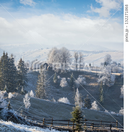 Winter coming. Picturesque foggy and moody morning scene in late autumn mountain countryside with hoarfrost on grasses, trees, slopes. Ukraine, Carpathian Mountains. Winter coming. Picturesque foggy and moody morning scene in late autumn mountain countryside with hoarfrost on grasses, trees, slopes. Ukraine, Carpathian Mountains. 132271868