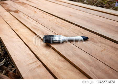 Paint brush and wood material in construction work. Paint brush and wood material in construction work. 132271878