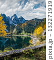 Peaceful autumn Alps mountain lake with reflections. Gosauseen or Vorderer Gosausee lake, Upper Austria. Dachstein summit and glacier in far. 132271919