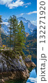 Peaceful autumn Alps mountain lake with clear transparent water and reflections. Gosauseen or Vorderer Gosausee lake, Upper Austria. Dachstein summit and glacier in far. 132271920