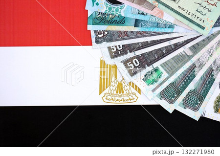 Egyptian pound currency money bills lies on flag close up. The concept of business and investment 132271980