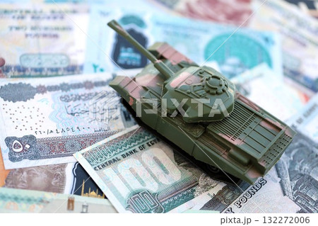 Egyptian pound currency money bills and toy tank close up. The concept of army funds and weapons sales 132272006