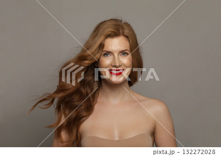 Beauty portrait of mid aged mature woman looking at camera and smiling. Beauty portrait of mid aged mature woman looking at camera and smiling. 132272028