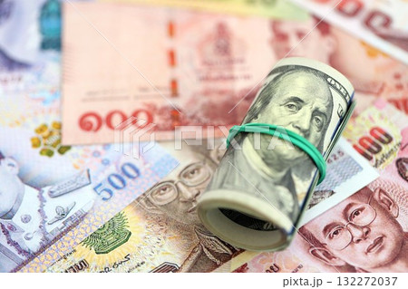 Thai baht currency money bills and bunch of us dollar banknotes close up. The concept of economics and currency exchange 132272037