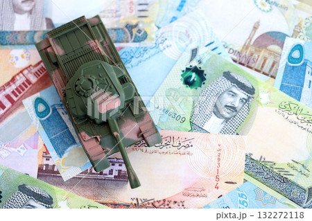 Bahraini dinar currency money bills and toy tank close up. The concept of army funds and weapons sales Bahraini dinar currency money bills and toy tank close up. The concept of army funds and weapons sales 132272118