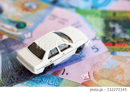 Kuwaiti dinar currency money bills and toy car close up. The concept of car ownership Kuwaiti dinar currency money bills and toy car close up. The concept of car ownership 132272145