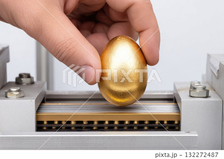 Hand holding golden egg above metal machine, minimal modern surreal concept, symbolizing value, wealth, investment, and creativity in industrial setting, with focus on innovation and uniqueness Hand holding golden egg above metal machine, minimal modern surreal concept, symbolizing value, wealth, investment, and creativity in industrial setting, with focus on innovation and uniqueness 132272487