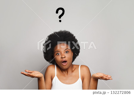 Woman a question mark painted above her head on gray background Woman a question mark painted above her head on gray background 132272806
