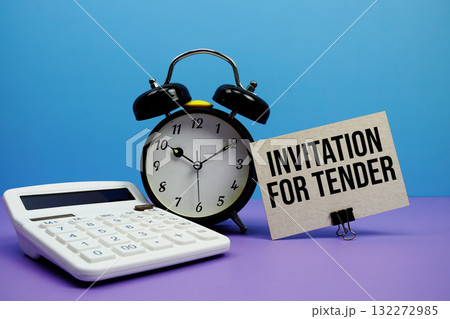 Invitation For Tender text with calculator and alarm clock on blue and purple background Invitation For Tender text with calculator and alarm clock on blue and purple background 132272985