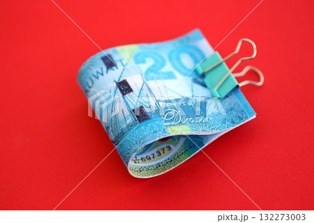 Kuwaiti dinar money bills in big amount on red close up. Finance and banking concept Kuwaiti dinar money bills in big amount on red close up. Finance and banking concept 132273003