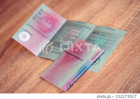 German temporary Permanent resident card specimen lies on wooden table close up. Fiktionsbescheinigung 132273027
