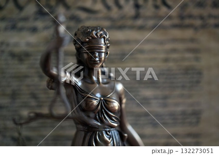 Dark scene with Lady Justice and background of US Constitution page. Lawsuit and judgement in United States of America 132273051
