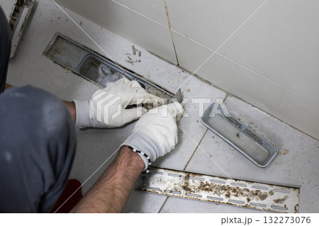 Mold damage problem in bathroom. Worker repairing sewer and bathroom drain Mold damage problem in bathroom. Worker repairing sewer and bathroom drain 132273076