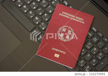 Greece passport lies on black laptop keyboard buttons background close up. Technologies and control in Europe concept 132273091