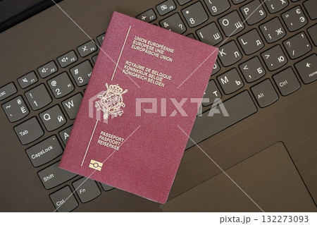 Belgium passport lies on black laptop keyboard buttons background close up. Technologies and control in Europe concept Belgium passport lies on black laptop keyboard buttons background close up. Technologies and control in Europe concept 132273093