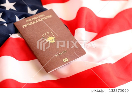 Slovenia passport on big waving flag of United States of America close up. US Visa and immigration concept 132273099