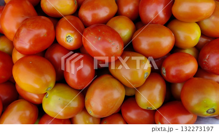 closeup view of ripe red plum tomatoes highlighting their smooth skin and vibrant color perfect for sauces, salads and culinary creations closeup view of ripe red plum tomatoes highlighting their smooth skin and vibrant color perfect for sauces, salads and culinary creations 132273197