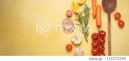 Cooking ingredients, fresh vegetables and wooden spoon on yellow background with copy space, cooking background 132273244