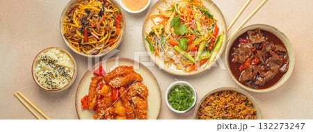 Variety of Chinese food dishes top view on table with chopsticks, light beige background, cuisine of China Variety of Chinese food dishes top view on table with chopsticks, light beige background, cuisine of China 132273247