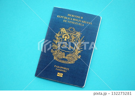 Venezuelan passport book on light blue paper background close up. Travel document on blue surface 132273281