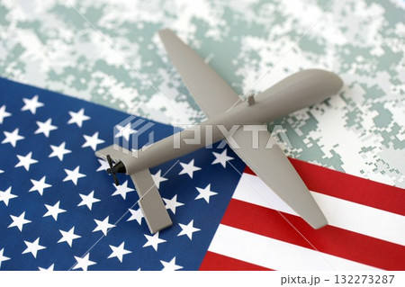 Drone unmanned autonomous technology of espionage and strikes on the enemy. Toy uav drone on US flag close up Drone unmanned autonomous technology of espionage and strikes on the enemy. Toy uav drone on US flag close up 132273287