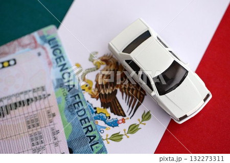 Mexican driving permit concept. Toy car and driver license on flag close up 132273311