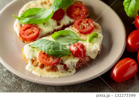 Hot open sandwiches with mozzarella, tomatoes and basil. Hot open sandwiches with mozzarella, tomatoes and basil. 132273399