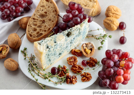 Gorgonzola cheese with walnuts, red grapes, and thyme. 132273413