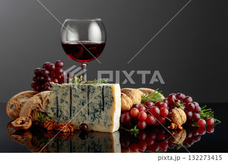 Gorgonzola cheese with ciabatta, walnuts, grapes, and red wine. 132273415