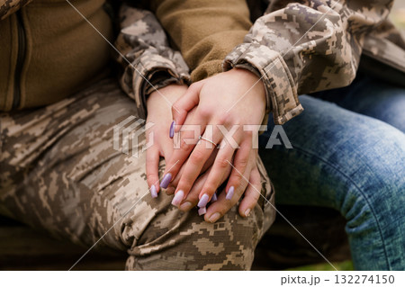 Romantic Hands Holding with Diamond Ring, Military Camouflage, Denim, Love, Partnership, Outdoors, Soft Focus, Warm Tones, Relationship Goals. 132274150