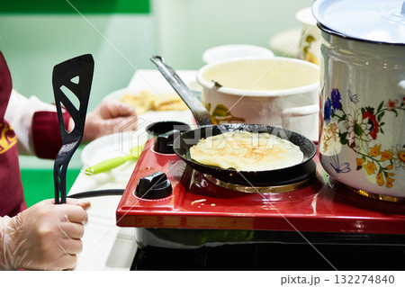 Cooking pancakes on stove Cooking pancakes on stove 132274840