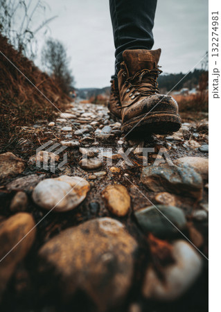Person wearing hiking boots walking on a wet rocky path in a forest landscape Person wearing hiking boots walking on a wet rocky path in a forest landscape 132274981