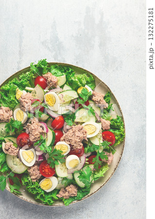 Tuna salad, vegetable salad with quail eggs, lettuce, red onion and cucumbers, on a light gray table, keto food, lifestyle, healthy eating, selective focus, top view, no people, Tuna salad, vegetable salad with quail eggs, lettuce, red onion and cucumbers, on a light gray table, keto food, lifestyle, healthy eating, selective focus, top view, no people, 132275181