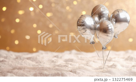 A greeting card with foil balloons on snow, a festive sparkling background. Banner with copy space, warm Christmas atmosphere 132275469