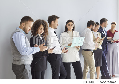 Diverse business team applicants waiting standing, businesspeople in row, queue for job interview Diverse business team applicants waiting standing, businesspeople in row, queue for job interview 132275682