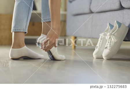 Orthopedic insoles showing prevention of flat feet, healthy walking, posture balance and care Orthopedic insoles showing prevention of flat feet, healthy walking, posture balance and care 132275683
