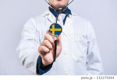 Doctor holding stethoscope with swedish flag. Sweden health and care concept 132275844