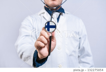 Doctor hands holding stethoscope with Finland flag. Finland health and care concept Doctor hands holding stethoscope with Finland flag. Finland health and care concept 132275854