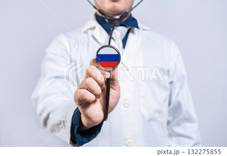 Doctor hands holding stethoscope with Russia flag. Russia health and care concept Doctor hands holding stethoscope with Russia flag. Russia health and care concept 132275855