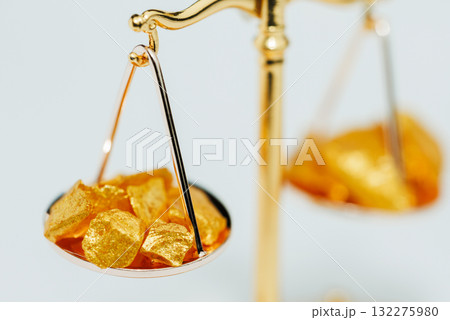 Beautiful Golden Balance Scales with little pieces of gold. Gold cost climbing up. Finance, gold theme Beautiful Golden Balance Scales with little pieces of gold. Gold cost climbing up. Finance, gold theme 132275980