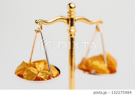 Beautiful Golden Balance Scales with little pieces of gold. Gold cost climbing up. Finance, gold theme 132275984