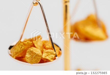 Beautiful Golden Balance Scales with little pieces of gold. Gold cost climbing up. Finance, gold theme Beautiful Golden Balance Scales with little pieces of gold. Gold cost climbing up. Finance, gold theme 132275985