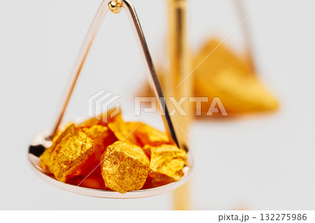 Beautiful Golden Balance Scales with little pieces of gold. Gold cost climbing up. Finance, gold theme Beautiful Golden Balance Scales with little pieces of gold. Gold cost climbing up. Finance, gold theme 132275986