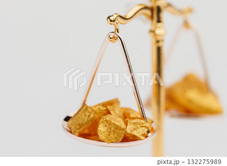 Beautiful Golden Balance Scales with little pieces of gold. Gold cost climbing up. Finance, gold theme 132275989