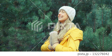 Calm relaxed healthy woman meditates in winter forest, girl practicing doing yoga exercises outdoors 132276042