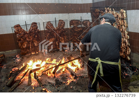 Gaucho roast barbecue, sausage and cow ribs, traditional argentine cuisine, Patagonia, Argentina. 132276739