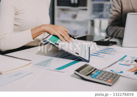 Accounting company provide finance and taxation planning for profitable cash flow, Auditor and accountant team working in office, analyze financial data and accounting record with calculator.Insight 132276859